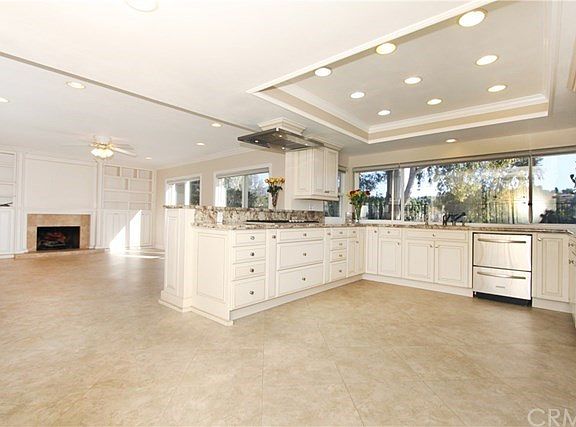 Open floor plan kitchen and family room with recessed lighting, upgraded appliances, fireplace, and tons of natural light!