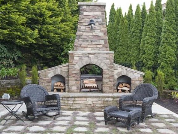 Outdoor double sided fire place, hot tub behind it:) tub and