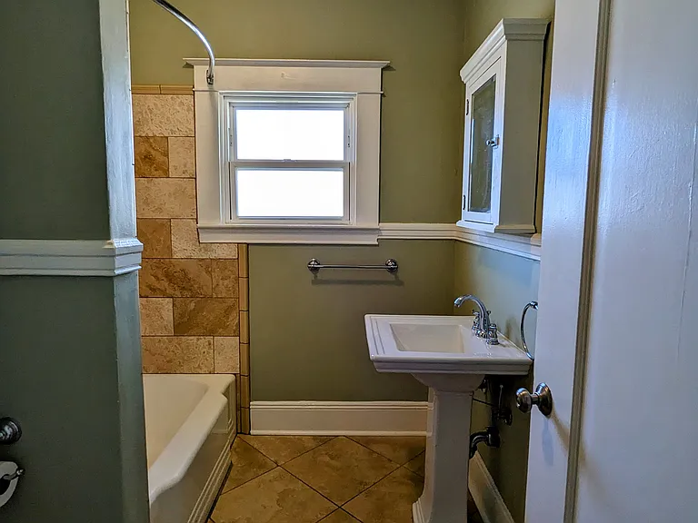 Elegant travertine floor and shower surround.