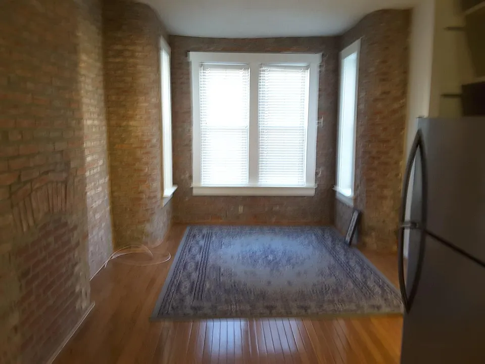 Living Room with Exposed Brick and Hardwood floors.