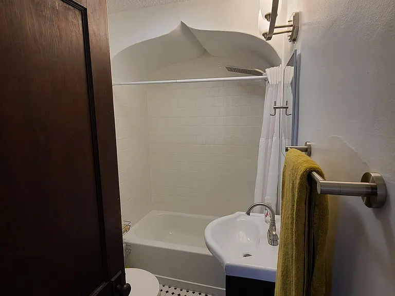 New Bathroom featuring Custom Tile Shower Walls and Flooring with brand new toilet, vanity, medicine cabinet, towel bars, and lighting