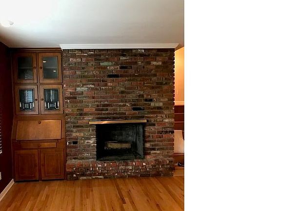 Stunning brick fireplace.   Built in desk has beautiful stain glass windows.