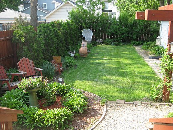 Beautiful yard w/ pergala & gardens