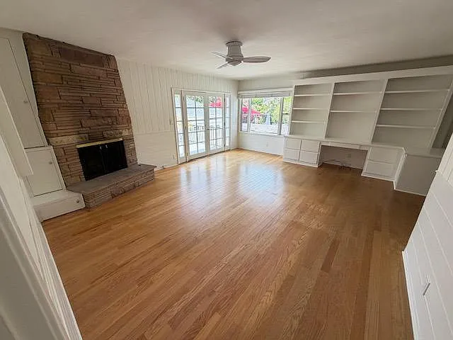 Family room with gas fireplace and built-in desk and book shelves.