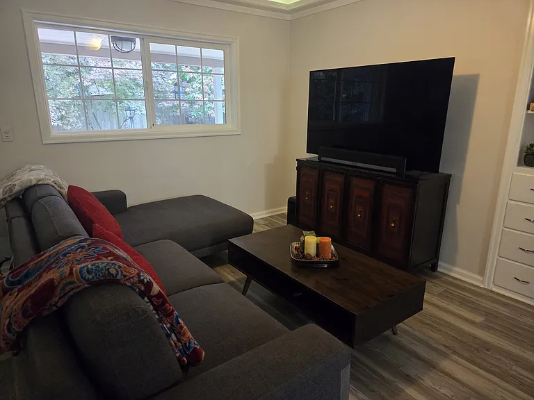 A cozy movie night awaits. Settle into the plush sofa and enjoy your favorite shows on the crisp 65" TV, just steps away from the kitchen for easy snack refills.