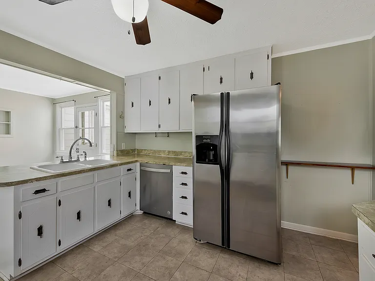 Photo 10. Stainless steel fridge, dishwasher, farm style sink in the center