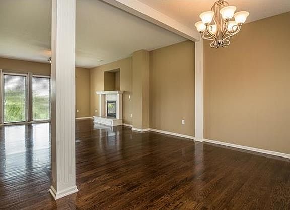 Gleaming hardwood floors greet you when you step inside the foyer.  Formal dining room is on the right and open floor plan leads to the large family room with fireplace.  TV fits in the niche above the fireplace.