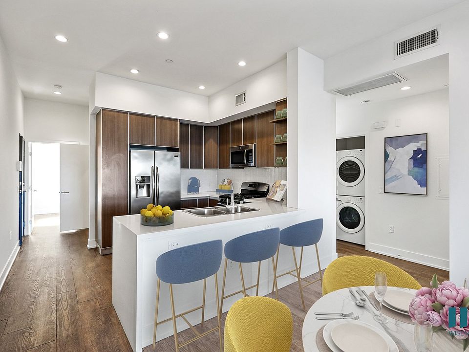 Open-Concept Kitchen with Countertop-Bar, Energy-Efficient Appliances, and In-Suite Washer & Dryer