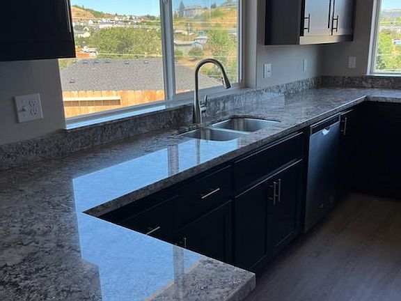 Kitchen has stainless steel appliances.