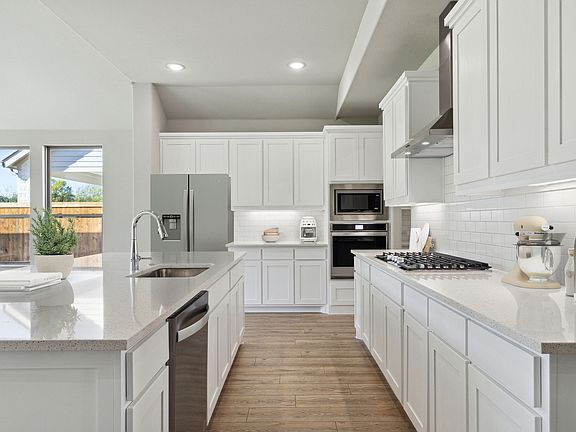 Kitchen in the Morrison home plan by Trophy Signature Homes - REPRESENTATIVE PHOTO