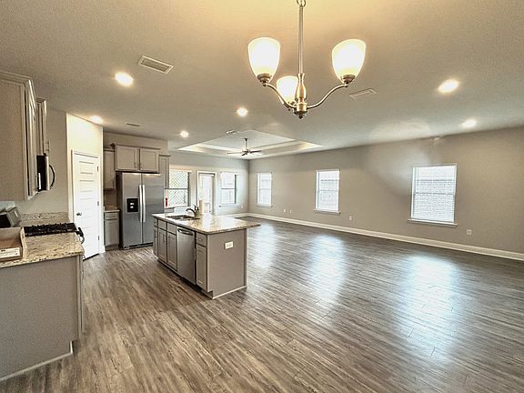 Abundant can and natural light throughout living/dining/kitchen area. Luxury vinyl plank throughout.