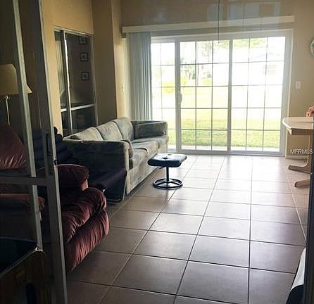 Florida room with an excellent view of the backyard and slider to a patio.