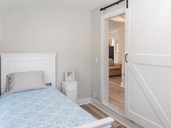 First floor bedroom is quaint with sliding barn door (no closet)