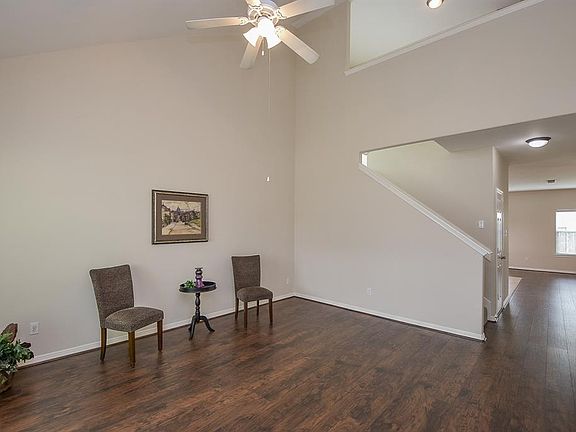 Open the door and take in the soaring ceiling and gorgeous new flooring of the expansive living room.