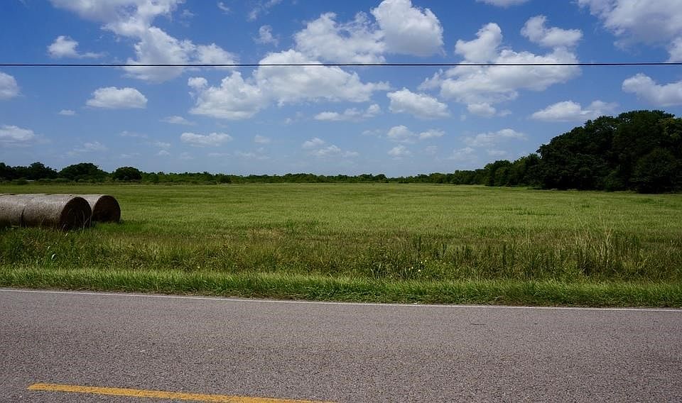 Land view from CR172, hay bales from property.