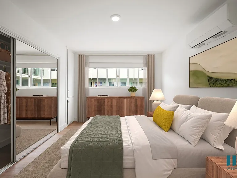 Spacious Bedroom with a Mirrored Closet and Vinyl Flooring