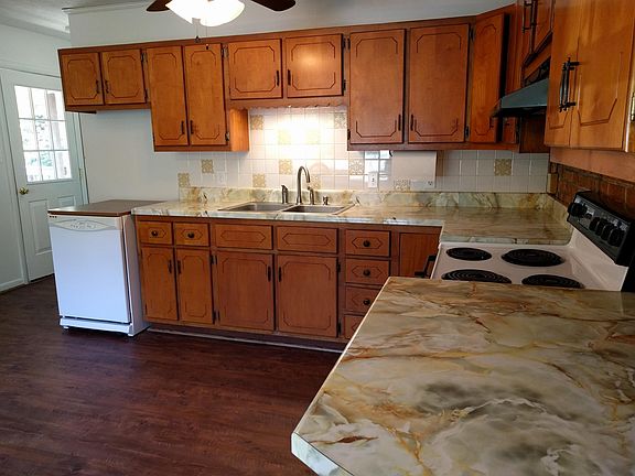 There is a bathroom to the left of the kitchen door, and steps that go down to the basement. We used the finished part of the basement as a fourth bedroom. There is lots of room in the unfinished part for storage, which also contains laundry hook-ups, a