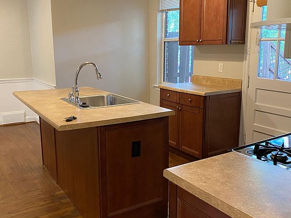 Looking at the kitchen from the hallway by the bathroom.