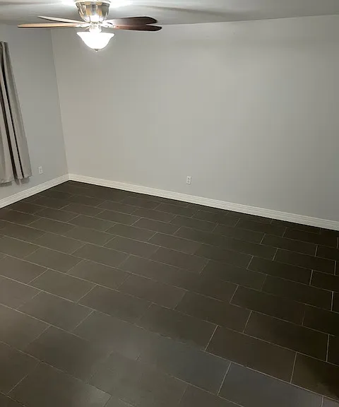 Living Room: Front Window, New Curtains, Tile and Grout Flooring, Freshly Painted Ceiling, Walls, Baseboards, Doors and Moldings, Ceiling Fan with Light.