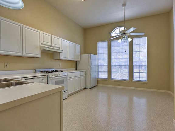Open kitchen with natural lighting. Flooring is recent.