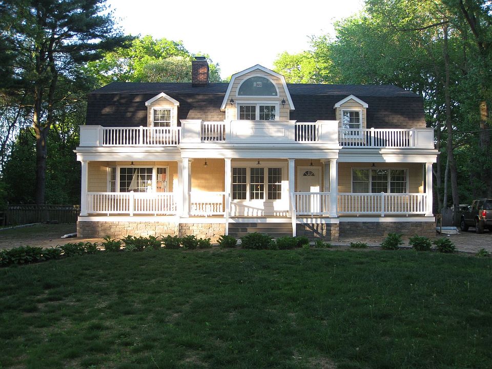 House reconstructed to include front porch and balcony, new siding, new roof