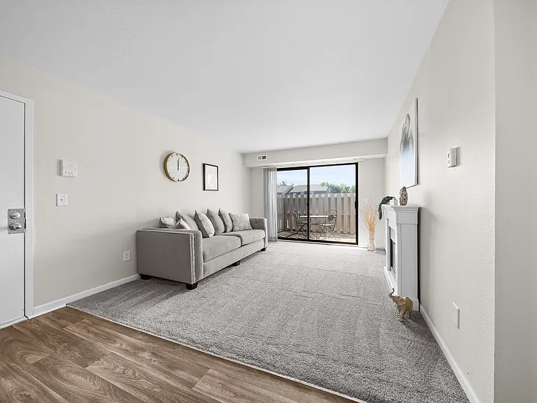 Large living room with patio at Three Oaks Apartments in Troy, Mi