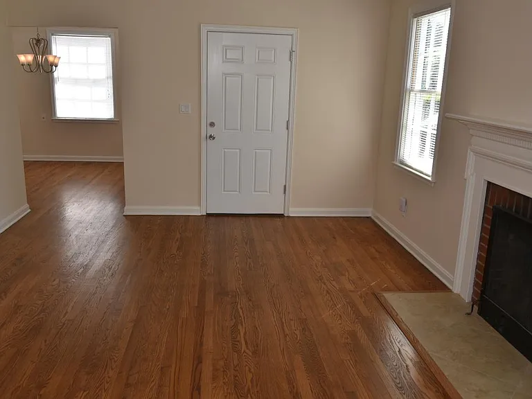 Living & dining rooms.: refinished floors, fireplace, paneled entry door w/ deadbolt