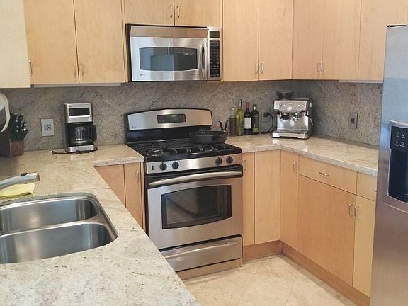 kitchen with lots of stoarge space. Addidtional large storage under stairs.