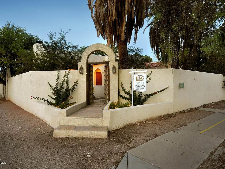 Front courtyard entrance with old Mexican gates.