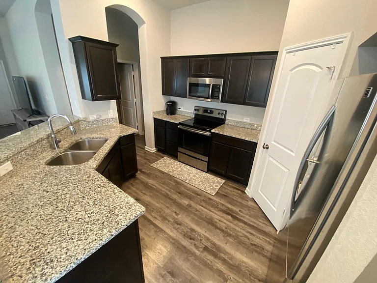 Kitchen with stainless steel appliances, granite counter tops, and large pantry