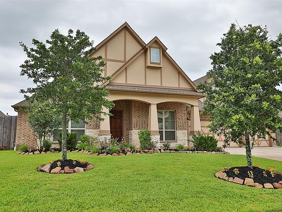 Well landscaped with moss rock and fresh mulch. Sprinklers in the front and backyard.