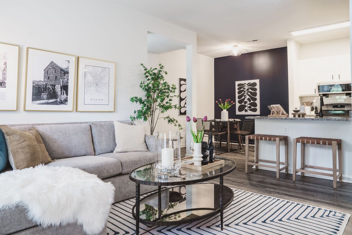 Renovated apartment home featuring an open floor plan, comfortable seating, and stylish cabinetry