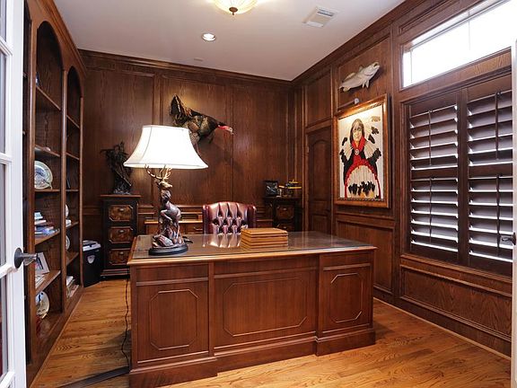 Study with wood paneling and shelves