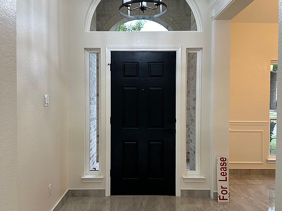 Front entry from inside. Formal dining room on the right.