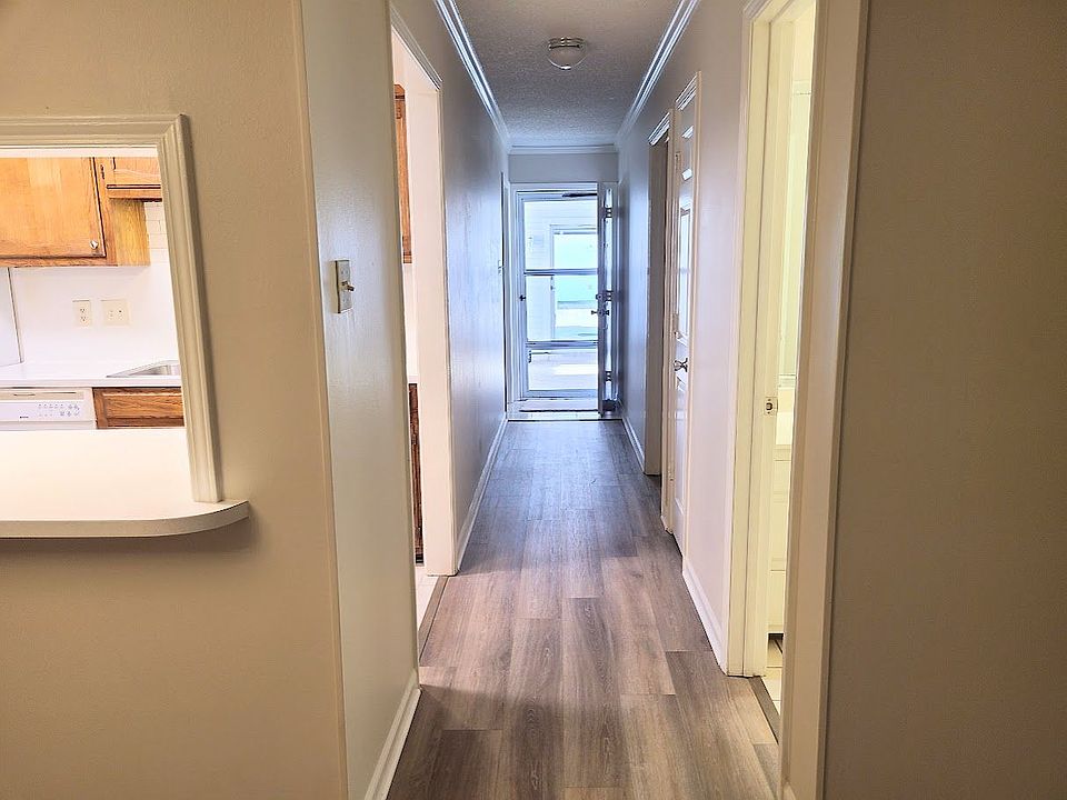 View from front door to back door leading to private patio and enclosed garage