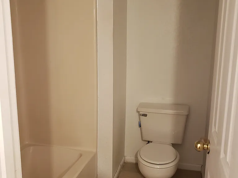 Toilet and tub room to full bathroom upstairs.