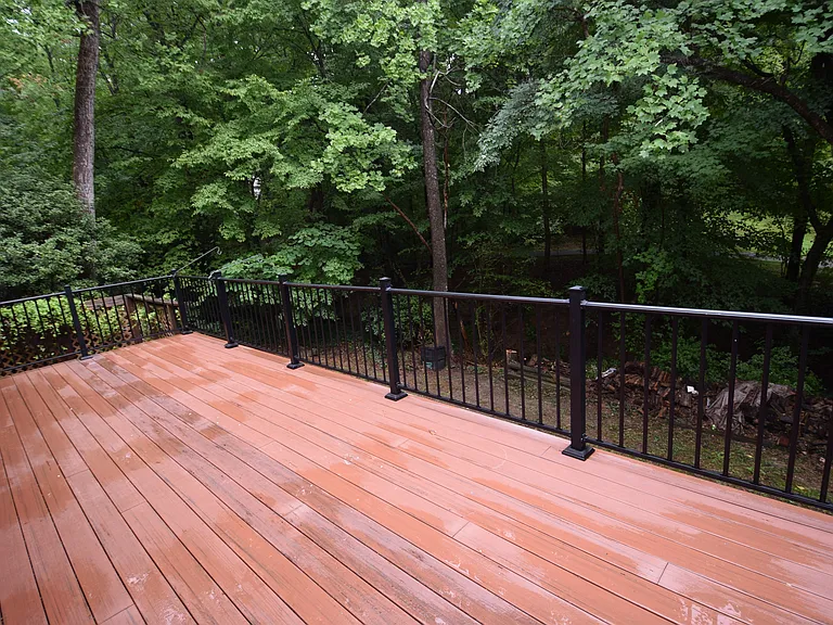 Main deck overlooking woods and walking trail.