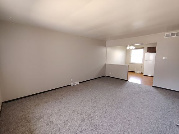 Large living room leading to kitchen.