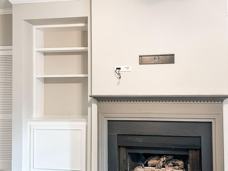 built in shelving, gas fireplace, and prepped to hang a tv