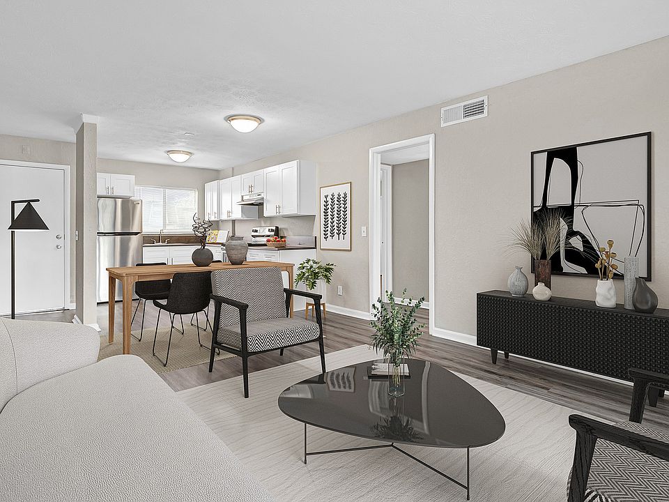 Modern open-concept living and dining area with sleek kitchen, stylish decor, and abundant natural light.