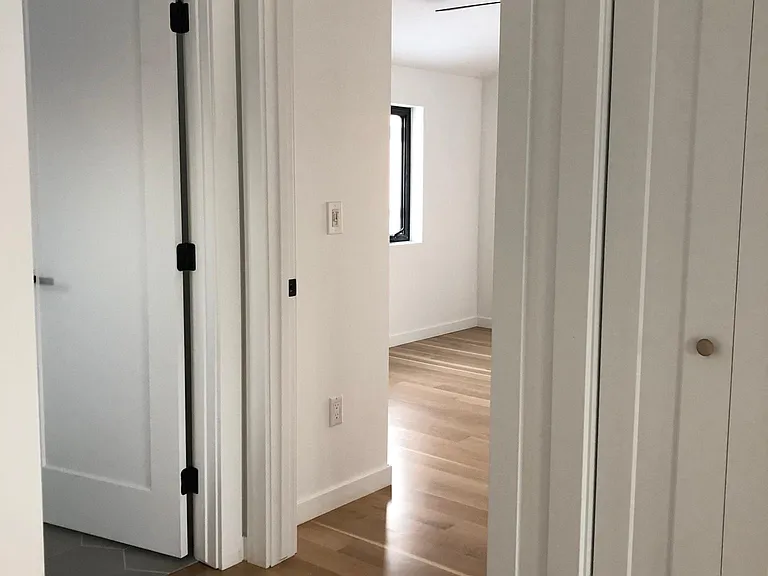 At top of stairs, in hallway looking at (from left) bathroom (see gray tile), bedroom, coat closet