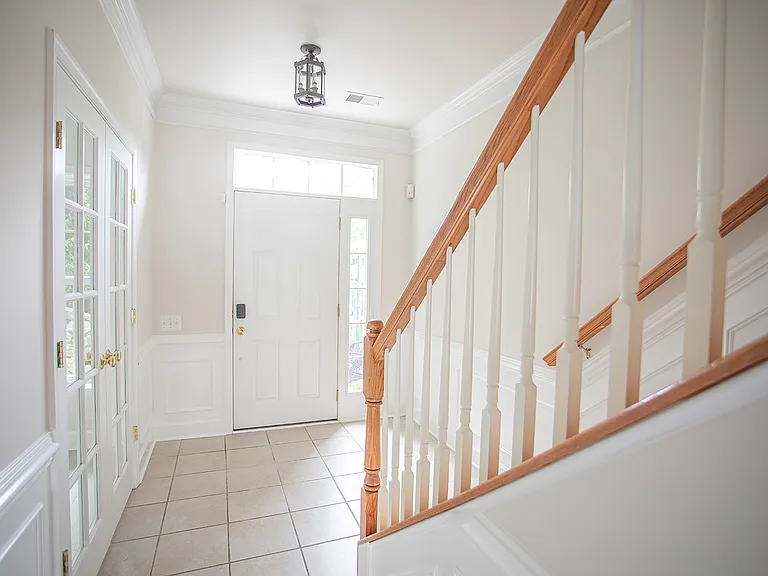 Walking in through the garage, office is on the left through the french doors