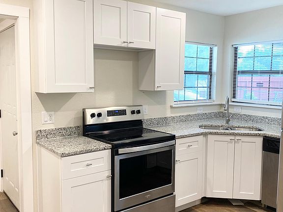 Brand new shaker style cabinets with granite countertops and stainless steel appliances.