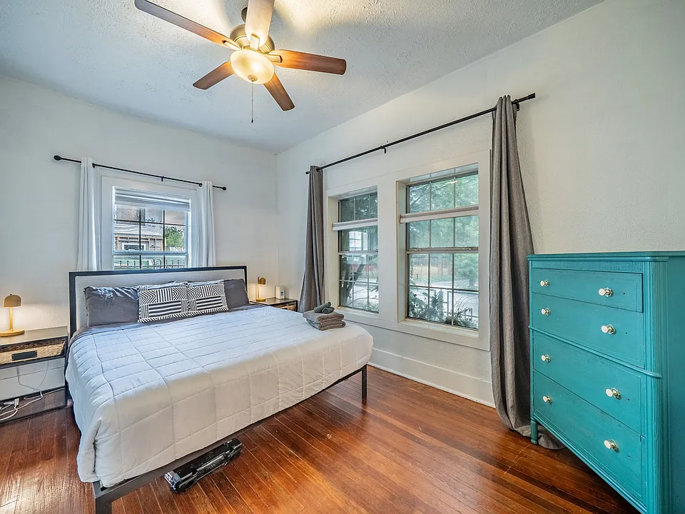 Relax in this bright, airy bedroom with stylish teal accents.
