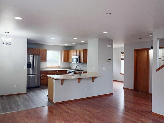 Kitchen with new floors and stainless steel appliances