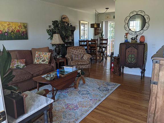 Entrance; living room leads to dining area, deck and kitchen.