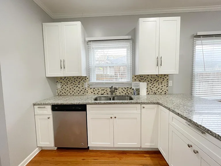 Kitchen with stainless steel appliances: electric stove, refrigerator, dishwasher