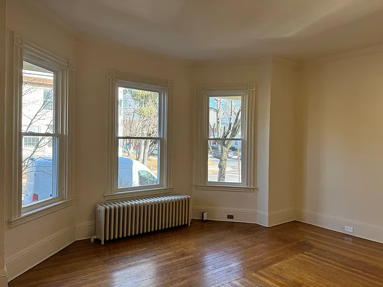 Living room with hardwood floor and new double hung Harvey windows