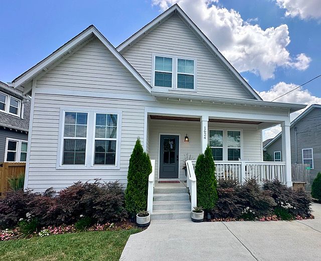Charming curb appeal with a welcoming front porch, fresh landscaping, and modern farmhouse style _ the perfect place to come home to.