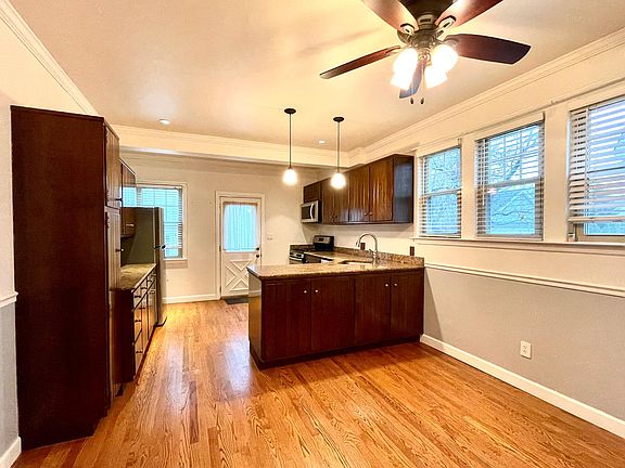 Kitchen with lots of cabinet storage, countertop space, and space for dining area. Exit to backyard.